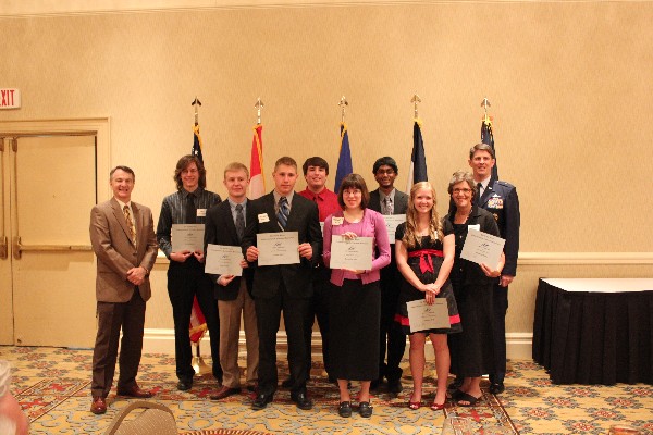 Gathering at the scholarship dinner in May are (l-r) Col. Rodney Pohlmann, USAF (Ret.), chapter vice president for education; chapter scholarship winners Eric Kaliamos, John Parish, Andrew Hurley, Daniel Schemmel, Katherine Wise, Phanindia Gaddipati, Suzanne Luff and Kathy Brown (standing in for her son, Alexander); and Brig. Gen. Ian R. Dickinson, USAF, director, communications and information, Headquarters, Air Force Space Command.